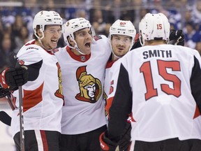 The Senators' Dylan DeMelo, centre, celebrates with Thomas Chabot, left, Mikkel Boedker and Zack Smith after scoring Ottawa's first goal of the game. Chabot had two goals on the night.