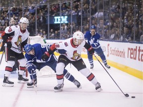 Senators defenceman Dylan DeMelo (2) holds off Maple Leafs forward Tyler Ennis during the second period of last Saturday's game in Toronto.