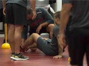 Senators centre Jean-Gabriel Pageau sits on the floor of the gym after tearing his right Achilles tendon during fitness training on the first day of camp in September. He's facing a four- to six-month recovery process.