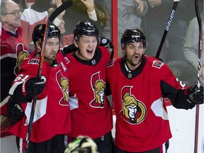 Senators winger Brady Tkachuk, middle, celebrates with Mark Stone, left, and Dylan DeMelo after scoring against the Stars in the third period of Monday's game.