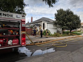 Firefighters at scene of blze in unoccupied bungalow at 100 Jolliet Ave. Vanier, Wednesday, Oct. 10.
