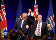 United Conservative Party Leader Jason Kenney and Ontario Premier Doug Ford cheer with supporters at an anti-carbon tax rally in Calgary, Friday, Oct. 5, 2018.