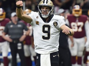 New Orleans Saints quarterback Drew Brees (9) reacts to a touchdown carry by running back Mark Ingram, not pictured, in the first half of an NFL football game against the Washington Redskins in New Orleans, Monday, Oct. 8, 2018.