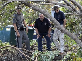 A New York state trooper and members of the National Transportation Safety Board view the scene of Saturday's fatal crash in Schoharie, N.Y., Sunday, Oct. 7, 2018.