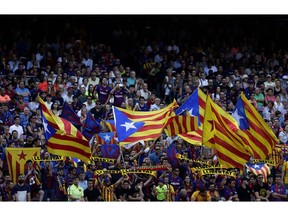FC Barcelona's supporters hold "estelada flags, that symbolise Catalonia's independence during the Spanish La Liga soccer match between FC Barcelona and Athletic Bilbao at the Camp Nou stadium in Barcelona, Spain, Saturday, Sept. 29, 2018.