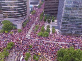 In this June 22, 2016 photo, the crowd wait in the parade route in downtown Cleveland to celebrate the Cavaliers basketball team's NBA championship. This photo showing a crowd of nearly one million people engulfing major roadways was not taken during a President Donald Trump rally in Houston this week, as several people falsely claimed on social media. Bruce Bishop/Elyria Chronicle-Telegram via AP