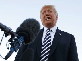 President Donald Trump speaks to media before boarding Air Force One at Elko Regional Airport, Saturday, Oct. 20, 2018, in Elko, Nev., after a campaign rally.