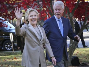 FILE - In this Nov. 8, 2016, file photo, Democratic presidential candidate Hillary Clinton, and her husband former President Bill Clinton, greet supporters after voting in Chappaqua, N.Y. T