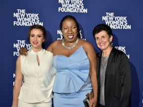 This Oct. 15, 2018 photo released by the New York Women's Foundation shows, from left, actress and activist Alyssa Milano, founder of the Me Too movement Tarana Burke and Ana Oliveira at The New York Women's Foundation's 2018 Radical Generosity gala in New York. Now that the #MeToo movement has passed the one-year mark, key voices in the movement are assessing progress and looking forward to the next phase.