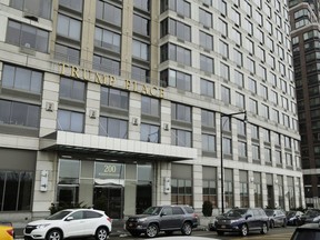 In this Thursday, Jan. 11, 2018, file photo, vehicles line the curb outside of "Trump Place," in New York. Residents in another New York City tower have voted to remove the Trump name from their building in a sign that the Republican president's brand is losing some its power. Condominium owners at Trump Place on the Upper West Side of Manhattan have joined three other buildings in the neighborhood in deciding to strip the president's brassy five-letter name from their 46-story building.