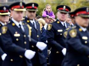 A girl watches the parade march off during the Canadian Police and Peace Officers Memorial Service on Parliament Hill in Ottawa on Sunday, Sept. 30, 2018.