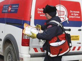 A Canada Post mail carrier in Toronto on Wednesday December 11, 2013.