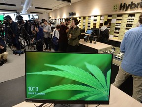 Members of the media attend a preview for one of Quebec's new cannabis stores in Montreal on Tuesday, Oct.16, 2018.
