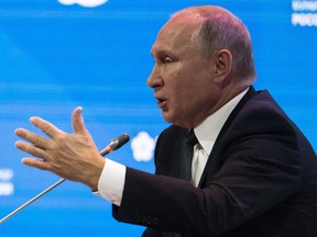Russian President Vladimir Putin gestures while answering questions at the Russian Energy Week International Forum in Moscow, Russia, Wednesday, Oct. 3, 2018.