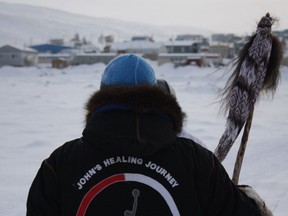 Anthony Kawapit stands overlooking Salluit during a 1,200-kilometre healing walk in the Nunavik region in April 2018.  Christopher Curtis photo