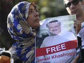 In this Friday, Oct. 5, 2018 file photo, Tawakkol Karman, the Nobel Peace Prize laureate for 2011 holds a picture of missing Saudi writer Jamal Khashoggi as she speaks to journalists near the Saudi Arabia consulate, in Istanbul, Turkey. Khashoggi was a Saudi insider. (AP Photo/Emrah Gurel, File)