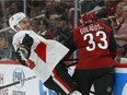 Ottawa Senators right wing Mark Stone gets checked away from the puck by Arizona Coyotes defenseman Alex Goligoski (33) in the third period of an NHL hockey game, Tuesday, Oct. 30, 2018, in Glendale, Ariz. Arizona defeated Ottawa 5-1.