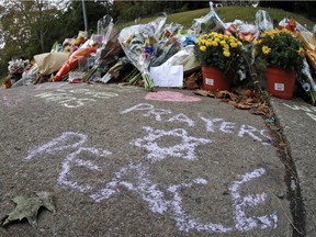 A spontaneous memorial of flowers and sidewalk writing near the Tree of Life Synagogue on Monday, Oct. 29, 2018.