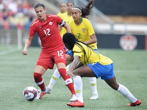Christine Sinclair, left, protects the ball from Brazil's Ludmila, bottom, and Andressa Alves during a Canadian women's team match in Ottawa on Sept. 2.
