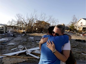 Samantha Martinez, right, cries Tuesday upon returning with her husband Rudy to their street and seeing the damage in person for the first time since Hurricane Michael hit Mexico Beach, Fla.