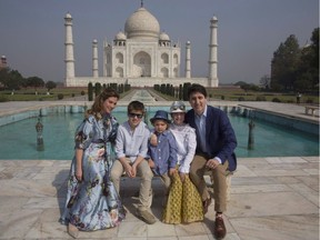 Canadian Prime Minister Justin Trudeau, his wife, Sophie Gregoire Trudeau, their sons Hadrien and Xavier, daughter Ella-Grace, second right, pose for the photographs in front of Taj Mahal, in Agra, India, on February 18, 2018. Prime Minister Justin Trudeau and his family are regularly showered with lavish gifts from dignitaries, but a growing trend among the high-priced offerings are gifts from clothing and accessory designers who use images of the Trudeaus wearing their wares for promotion.