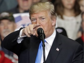 In this Oct. 26, 2018 photo, President Donald Trump points to the media as he speaks during a campaign rally in Charlotte, N.C. Trump is accusing the media of being "the true Enemy of People" in the wake of a mass shooting and a mail bomb plot.(AP Photo/Chuck Burton) ORG XMIT: WX101