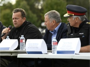Bryce Conrad, left, President and CEO of Hydro Ottawa, speaks as Anthony DiMonte, Ottawa's General Manager of Emergency and Protective Services, second from right, and Ottawa Police Chief Charles Bordeleau listen, at a press conference during the power outage after last month's tornado.