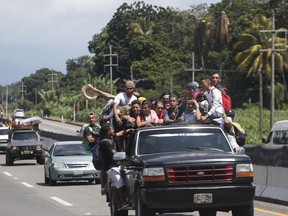 Central American migrants making their way to the U.S. in a large caravan fill the truck of a driver who offered them the free ride, as they arrive to Tapachula, Mexico, Sunday, Oct. 21, 2018. Despite Mexican efforts to stop them at the Guatemala-Mexico border, about 5,000 Central American migrants resumed their advance toward the U.S. border Sunday in southern Mexico.