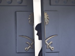 A Consulate staff is seen behind the entrance of the Saudi Arabia's Consulate in Istanbul, Wednesday, Oct. 17, 2018.