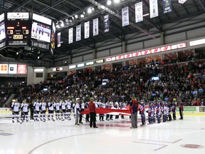 WINDSOR, ONTARIO -SEPTEMBER 24, 2015 The Windsor Spitfires stand at attention during the national anthem during the Ontario Hockey League opening game against the Erie Otters at the WFCU Centre in Windsor, Ontario on September 24, 2015. (JASON KRYK/The Windsor Star)
