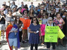 People gather to protest changes to Ontario's sex-ed curriculum at the Human Rights Monument in Ottawa on Sunday, July 15, 2018.