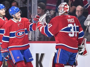 Goaltender Carey Price #31 congratulates Jesperi Kotkaniemi #15 of the Montreal Canadiens for his first career NHL goal against the Washington Capitals during the NHL game at the Bell Centre on November 1, 2018 in Montreal, Quebec, Canada.