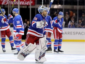 Henrik Lundqvist #30 of the New York Rangers and the rest of his teammates celebrate the 2-1 win over the Vancouver Canucks at Madison Square Garden on November 12, 2018 in New York City.