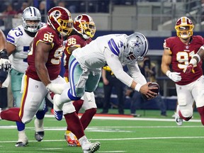 Dak Prescott #4 of the Dallas Cowboys dives into the end zone for a touchdown in the fourth quarter against the Washington Redskins at AT&T Stadium on November 22, 2018 in Arlington, Texas.