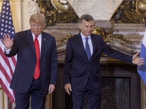 US President Donald Trump greets the press as President of Argentina Mauricio Macri shows the way to a meeting between the Presidents of Argentina and United States ahead of Argentina G20 Leaders' Summit 2018 at Casa Rosada on November 30, 2018 in Buenos Aires, Argentina.