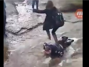 A shocking video posted to Facebook shows a 14-year-old Brett Corbett, lying face down in a rushing stream as another teen jumps onto him and then leapfrogs to the other side of the water to avoid getting wet. Around him are other students from Nova Scotia's Glace Bay High School -- watching, laughing, recording -- and one takes the opportunity to throw a rock at him.