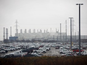 Vehicles sit parked outside of the General Motors Co. Oshawa assembly plant in Oshawa, Ontario, Canada, on Monday, Nov. 26, 2018.