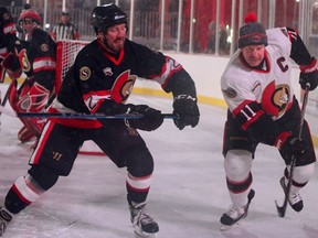 Lance Pitlick (left) chases Daniel Alfredsson (right) behind the net during the NHL 100 Classic on Parliament Hill, Dec. 15, 2017.