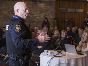 Ottawa police Deputy Chief Steve Bell addresses Barrhaven residents in attendance at a community meeting at the Cedarhill Golf and Country Club on Monday night.