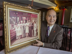 Wayner Wong is retiring and closing his family owned Wong's Palace restaurant after 41 years in business. Wayner holds a photo taken when he and his late wife Doreen (2nd from left in photo) opened the restaurant in 1978 with an official ribbon cutting by then Ottawa Mayor Marion Dewar. November 27, 2018.