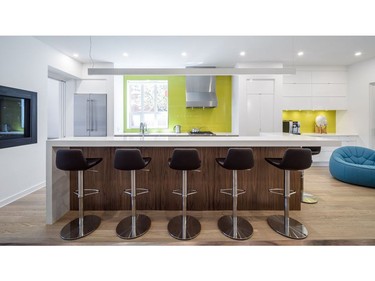 Prior to renovation the kitchen was secluded at the rear of the home. Now it's open design, bright features and avocado green accent walls make the place feel welcoming, comfortable and chic.