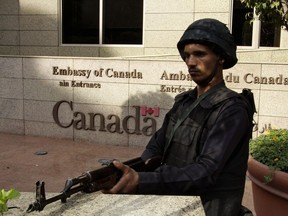 An Egyptian policeman stands guard outside the Canadian embassy in Cairo on December 8, 2014 after Canada joined Britain on closing its embassy in the Egyptian capital to the public for security reasons, with neither country providing details about any specific threat.