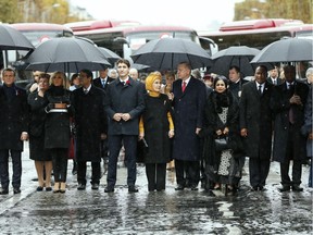 (FromL) French President Emmanuel Macron and his wife Brigitte Macron, Cyprus' President Nicos Anastasiades, Canadian Prime Minister Justin Trudeau, Turkish President's wife Emine Erdogan, Niger's President's Lalla Malika Issoufou, Niger's President Mahamadou Issoufou, Republic of Guinea's President Alpha Conde and his wife Djene Kaba Conde arrive at the Arc de Triomphe in Paris on November 11, 2018 to attend a ceremony as part of commemorations marking the 100th anniversary of the 11 November 1918 armistice, ending World War I.