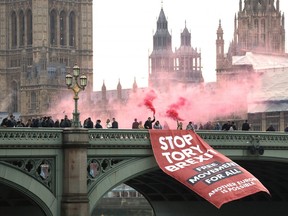 Anti-Brexit campaigners unfurl a banner on Westminster bridge on November 15, 2018 in front of the Houses of Parliament in London.