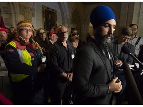 Surrounded by members of Canada Post NDP leader Jagmeet Singh listens to a question from the media about back to work legislation Friday November 23, 2018 in Ottawa.