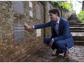 Canadian Prime Minister Justin Trudeau visits the grave stone of Esther Bernard as he visits the Fort Canning park in Singapore, Thursday November 15, 2018.Trudeau's ancestor, Esther Bernard, born Farquhar (1796-1838) was the daughter of Major-General William Farquhar (1774-1839), the first British Resident and Commandant of Singapore.