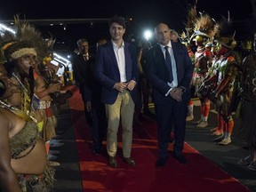 Canadian Prime Minister Justin Trudeau is greeted by Charles Abel, Deputy Prime Minister and Treasurer of Papua New Guinea as he arrives in Port Moresby, Papua New Guinea Friday November 16, 2018.