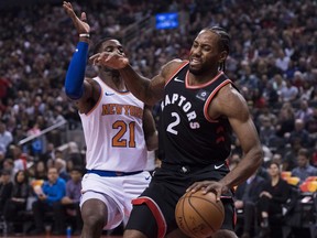 Toronto Raptors forward Kawhi Leonard (2) battles against New York Knicks guard Damyean Dotson (21) in Toronto on Saturday, Nov. 10, 2018.