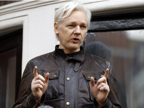 In this May 19, 2017 file photo, WikiLeaks founder Julian Assange gestures to supporters outside the Ecuadorian embassy in London, where he has been in self imposed exile since 2012.