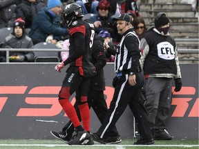 Ottawa Redblacks' Jonathan Rose (9) is walked off the field by an official during first-half CFL East Division Final football game action against the Hamilton Tiger-Cats in Ottawa, Ontario, Sunday, Nov. 18, 2018.